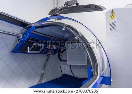 Interior of a hyperbaric oxygen chamber showing modern medical equipment, clean design, and a controlled therapeutic environment used for wellness, recovery, and oxygen therapy treatments.