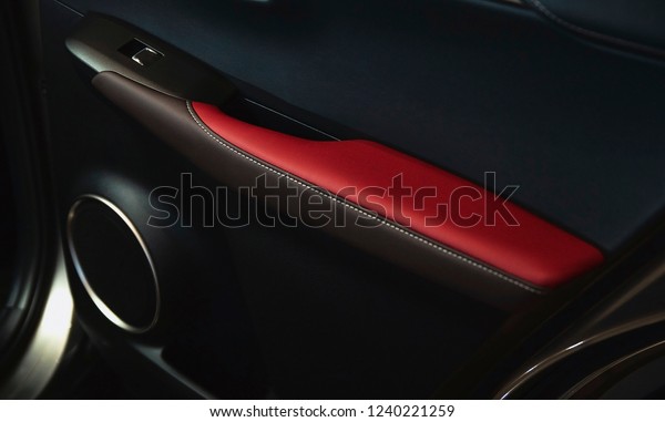 Interior\
inside the car. door upholstery leather red and black with glass\
buttons\
with handle, lock and audio\
tweeter