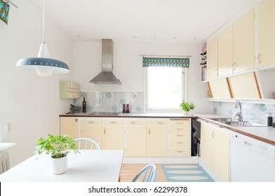 Interior Of A Kitchen In 50s Style And Yellow Cupboards