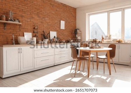 Interior of kitchen with counters, dining table and utensils