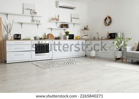 Interior of kitchen with Easter decor, white counters and shelves