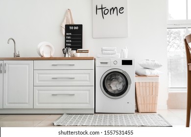 Interior of kitchen with modern washing machine - Shutterstock ID 1557531455