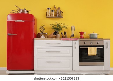 Interior of kitchen with red fridge, counters and shelf