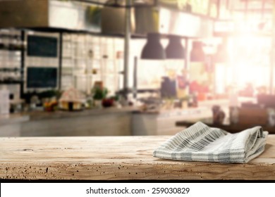 Interior Of Kitchen In Restaurant And Desk Of Wood And Napkin 