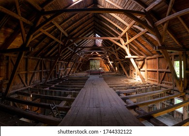 Interior of large old timber frame barn in Germany during renovation, upper floor wide angle shot