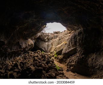 Interior of lava tube caves with sunlight leaking in