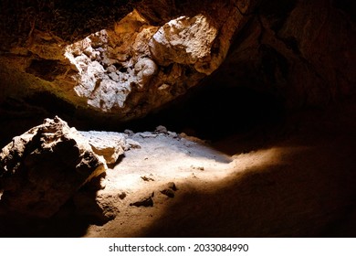 Interior of lava tube caves with sunlight leaking in