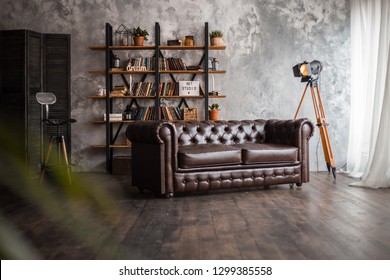 Interior With Leather Sofa And Luxury Lamp. Textured Background