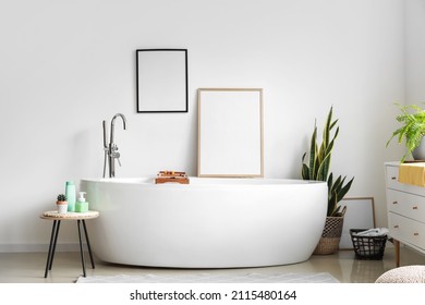 Interior Of Light Bathroom With Blank Frames