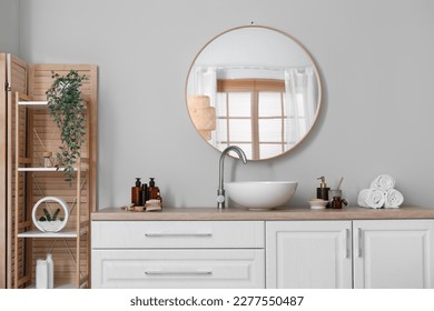 Interior of light bathroom with counters, sink and mirror - Shutterstock ID 2277550487