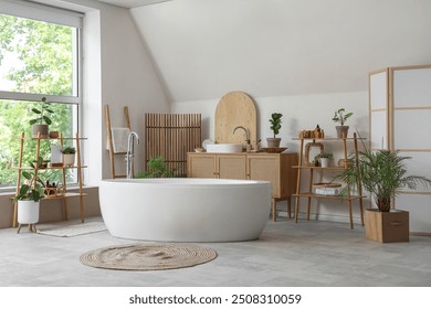 Interior of light bathroom with folding screen, bathtub and houseplants - Powered by Shutterstock