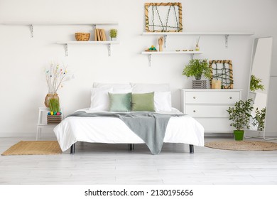 Interior of light bedroom with stepladder, commode and Easter eggs