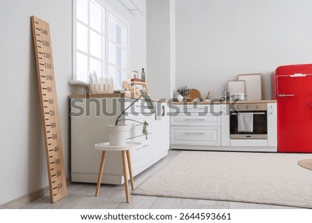 Interior of light kitchen with counters and stadiometer