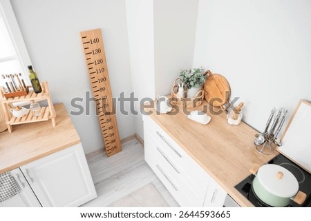 Interior of light kitchen with counters and stadiometer