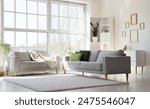 Interior of light living room with cozy grey sofas near big window