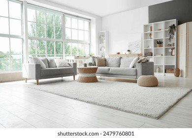 Interior of light living room with sofas, rattan table and soft carpet - Powered by Shutterstock
