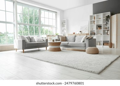 Interior of light living room with sofas, rattan table and soft carpet