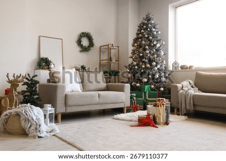 Interior of light living room with sofas, Christmas tree and presents