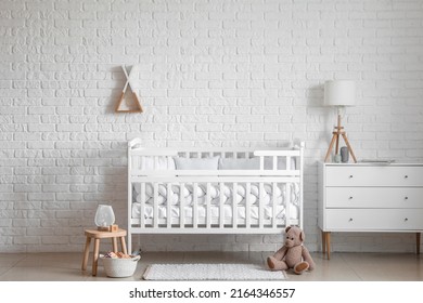 Interior Of Light Nursery With Baby Crib, Chest Of Drawers And Toys