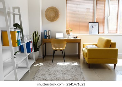 Interior Of Light Office With Shelving Unit And Modern Workplace