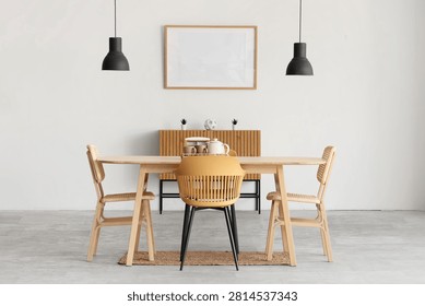 Interior of light room with blank frame, commode and dining table