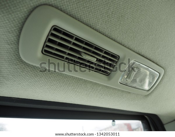 Interior lights in the car with air\
conditioning grille. Gray velor\
upholstery.\
\
