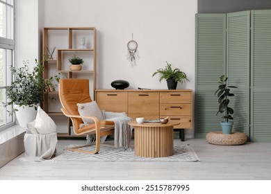 Interior of living room with armchair, glucophone and Tibetan singing bowl