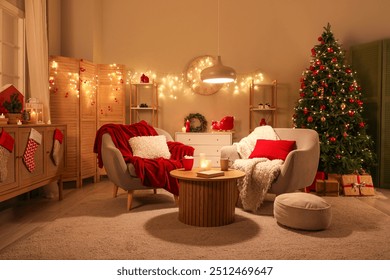 Interior of living room with armchairs, Christmas tree and glowing lights at night - Powered by Shutterstock