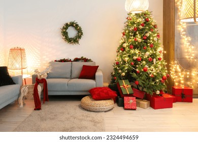 Interior of living room with Christmas tree, sofas and glowing lights