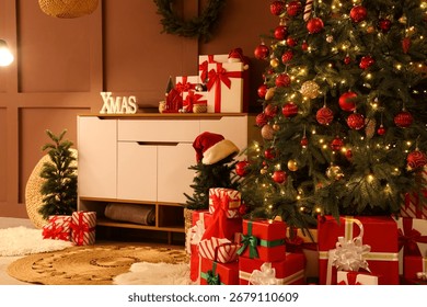Interior of living room with commode, Christmas trees and presents