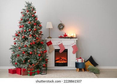 Interior of living room with fireplace, presents and Christmas tree