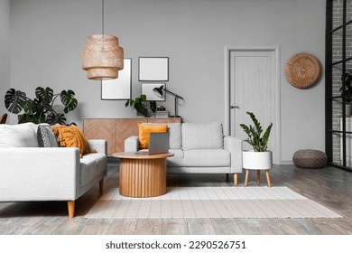 Interior of living room with green houseplants and sofas - Shutterstock ID 2290526751