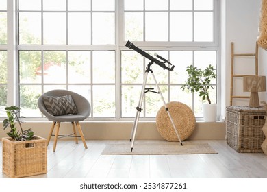 Interior of living room with grey armchair, houseplants and modern telescope near window - Powered by Shutterstock