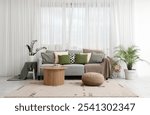 Interior of living room with grey sofa, table and plaids