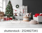 Interior of living room with grey sofas, Christmas tree, gift boxes and festive decorations