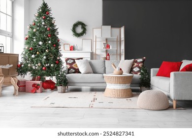 Interior of living room with grey sofas, Christmas tree, gift boxes and festive decorations - Powered by Shutterstock