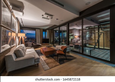 Interior of a living room in a luxury penthouse apartment in the evening - Shutterstock ID 1645872118