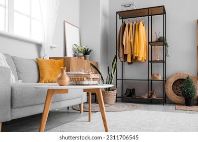 Interior of living room with shelving unit and clothes - Shutterstock ID 2311706545