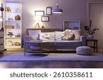 Interior of living room with sofa, shelf unit and glowing lamps in evening