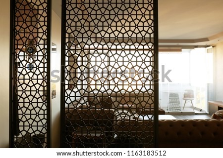 Interior of living room, view through decorative room divider