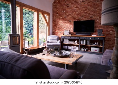 Interior Of Lounge With TV And Exposed Brick Walls In Modern Open Plan House Or Apartment