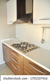 Interior of luxurious modern kitchen equipment, white and walnut cabinets