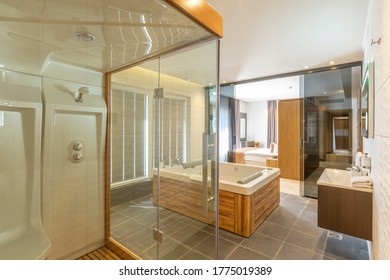 Interior of a luxury hotel bedroom with hydromassage bathtub and shower cabin