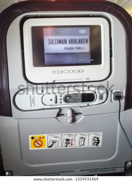 Interior of Malaysia Airlines plane\
seats, entertainment unit screen. Malaysia. April\
2019.