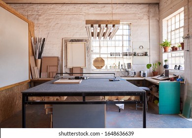 Interior of a manufacturing area of a picture framing studio with a variety of tools and different sized wooden frames - Shutterstock ID 1648636639