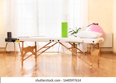 Interior of a massage or physical therapy treatment room with examination table.