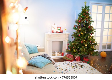 Interior Of Messy Living Room After Christmas Party: Colorful Confetti And Balloons Scattered Everywhere, Pile Of Gift Boxes Waiting For Its Owners, No People