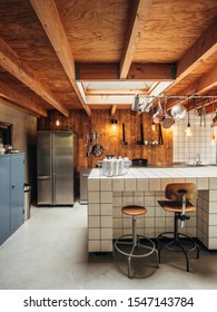 Interior Of A Midcentury Modern Kitchen With Barn Wood And Contestable With White Tiles.