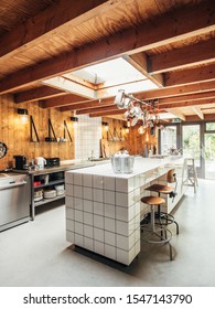 Interior Of A Midcentury Modern Kitchen With Barn Wood And Contestable With White Tiles.