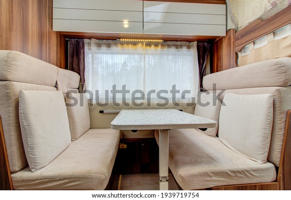 interior of a mobile\
home. Motorhome inside. Living area and dining room. Dinner table.\
Moscow 03.15.2021